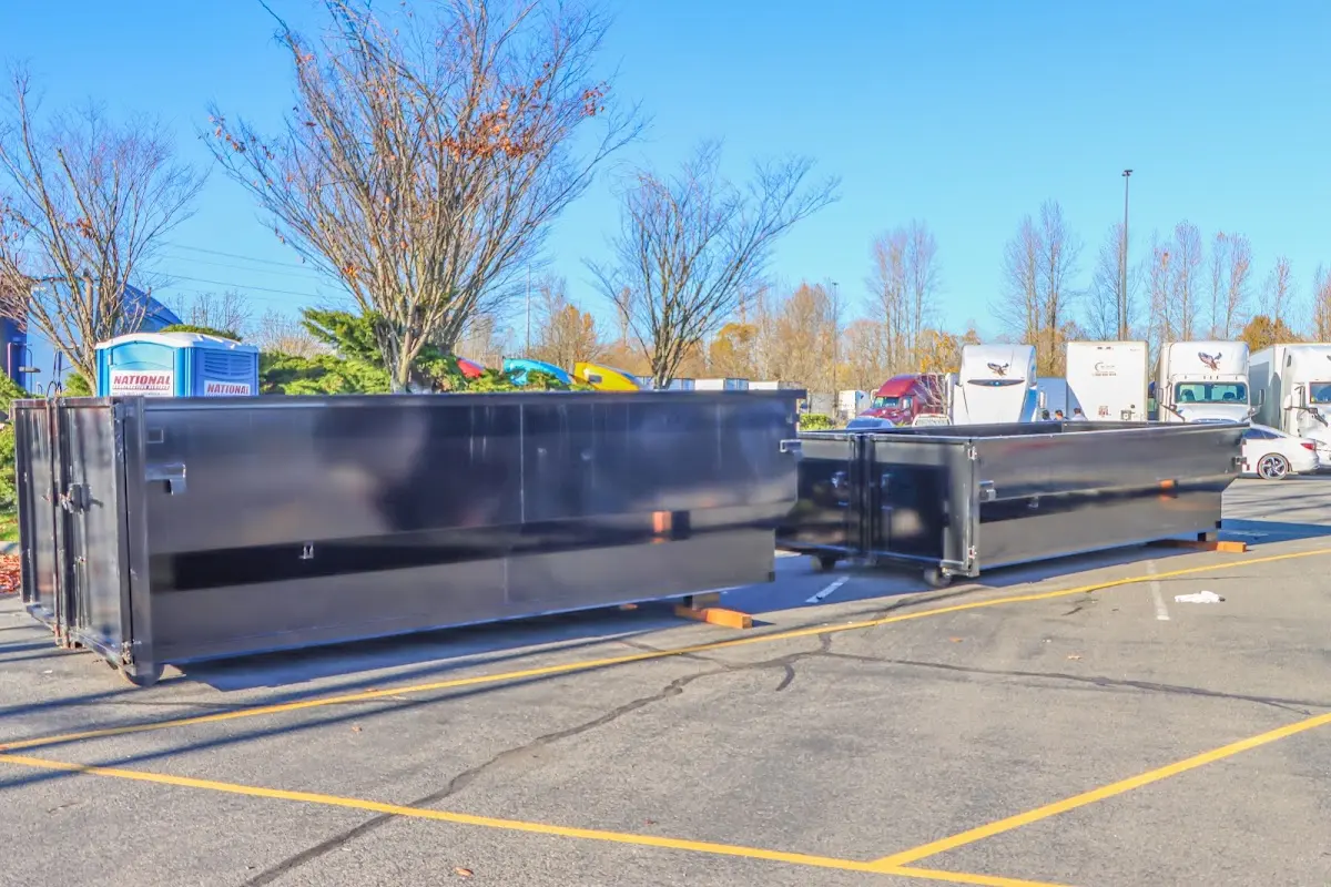 Professional dumpster rental service with roll-off container on residential driveway in Minnehaha